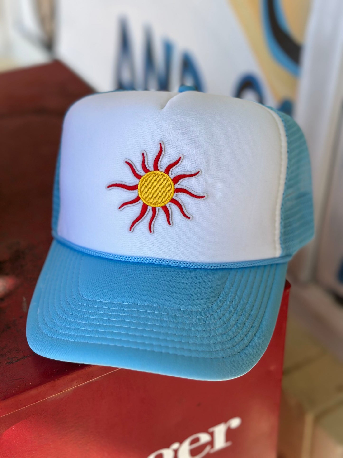 the sun never sets on a baddie trucker hat